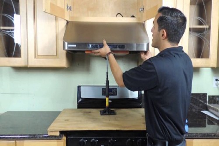 Technician cleaning a kitchen chimney filter